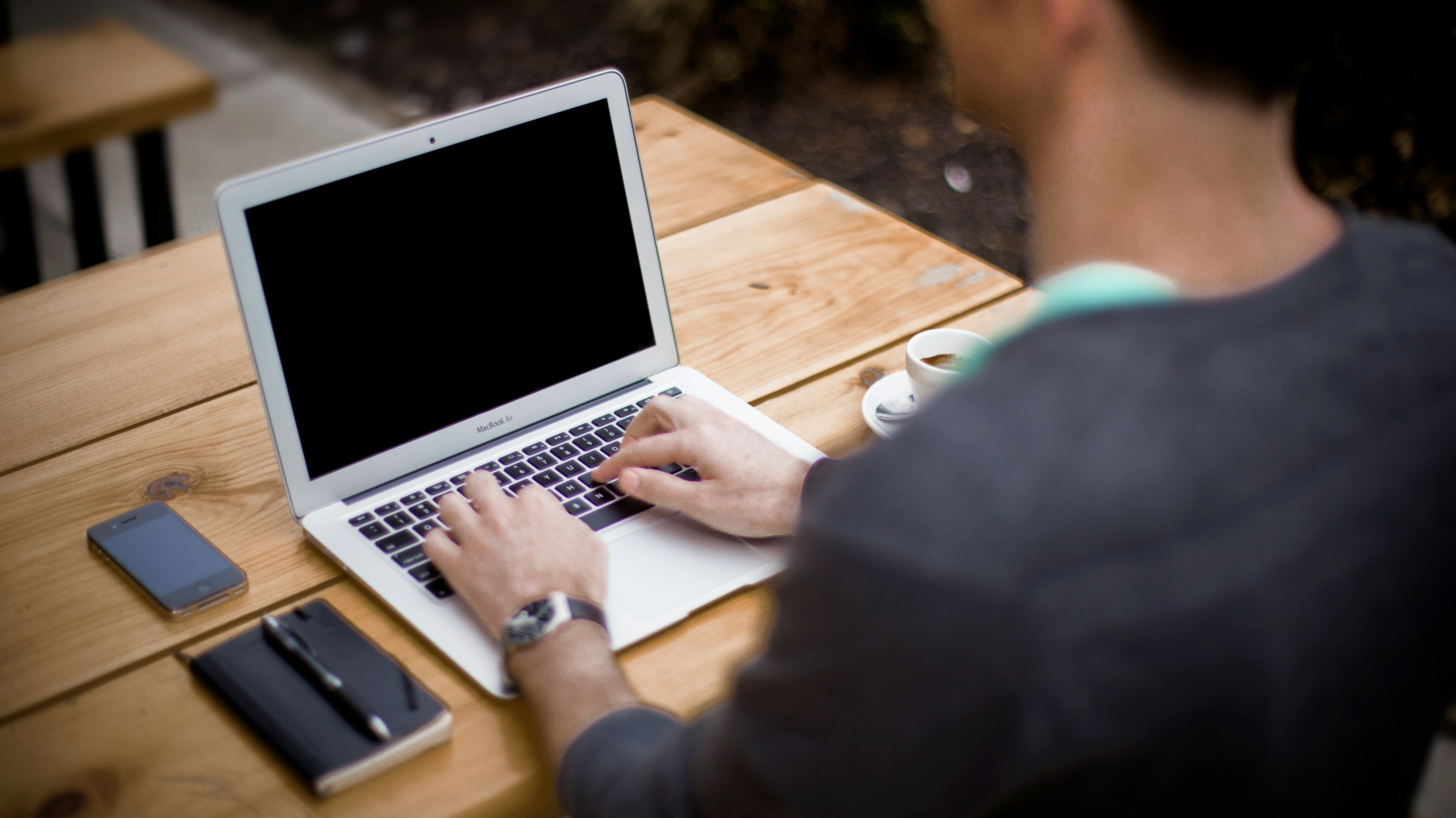 Person working on a laptop outdoors while maintaining good posture, illustrating the topic Are Posture Correctors Good for You Long Term.
