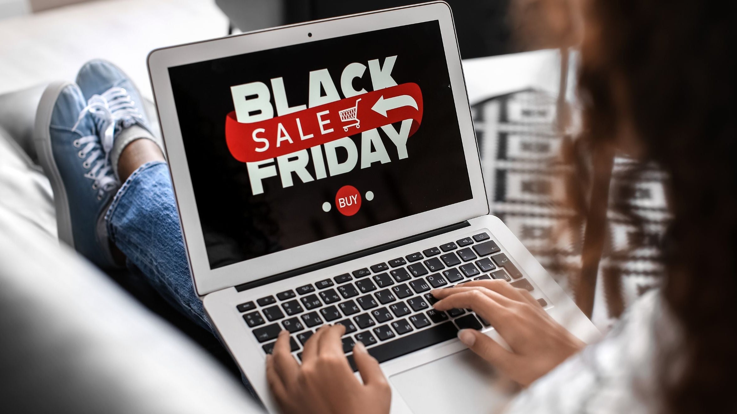 Laptop showing a Black Friday sale banner while checking deals for a black friday shopping guide.