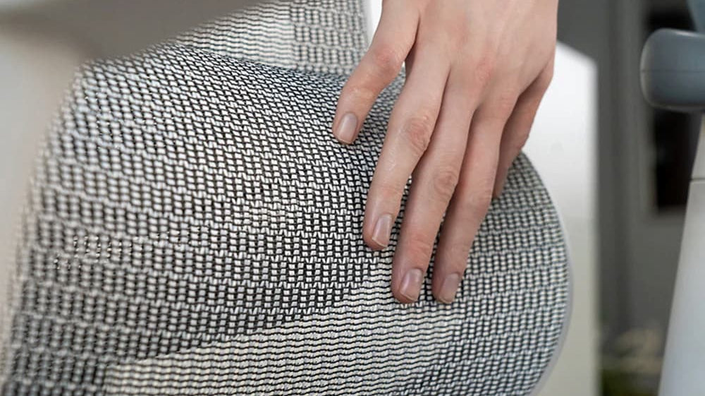 Close-up of a spotless ergonomic mesh chair illustrating how to clean an ergonomic office chair