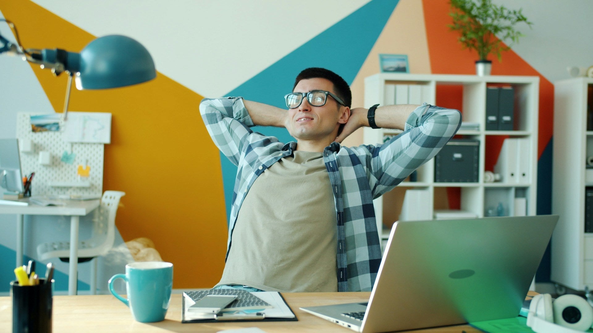 A man relaxing after hours of sitting with a correct posture doing computer work. Photo by Vitaly Gariev via www.unsplash.com