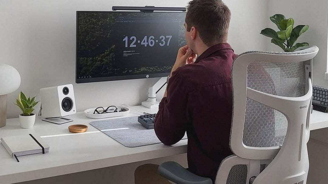 Minimalist workspace with laptop, notepad, and coffee-perfect for creating an EOFY 2025 guide setup.