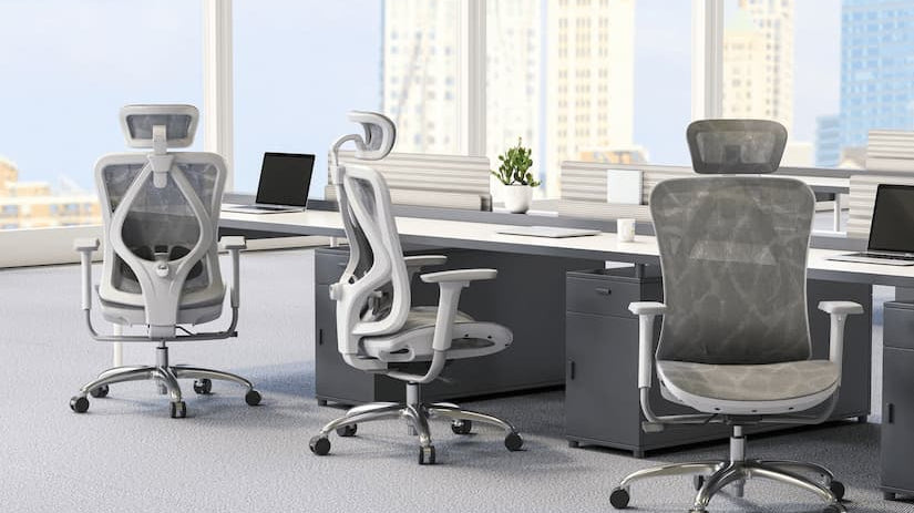 Modern office setup with ergonomic office chair for back pain, featuring mesh design, headrest, and lumbar support