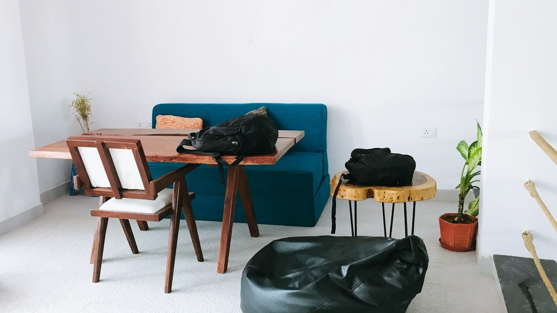 Minimalist room with table, chairs, and a black bean bag, showing casual seating alternatives to a gaming chair or bean bag