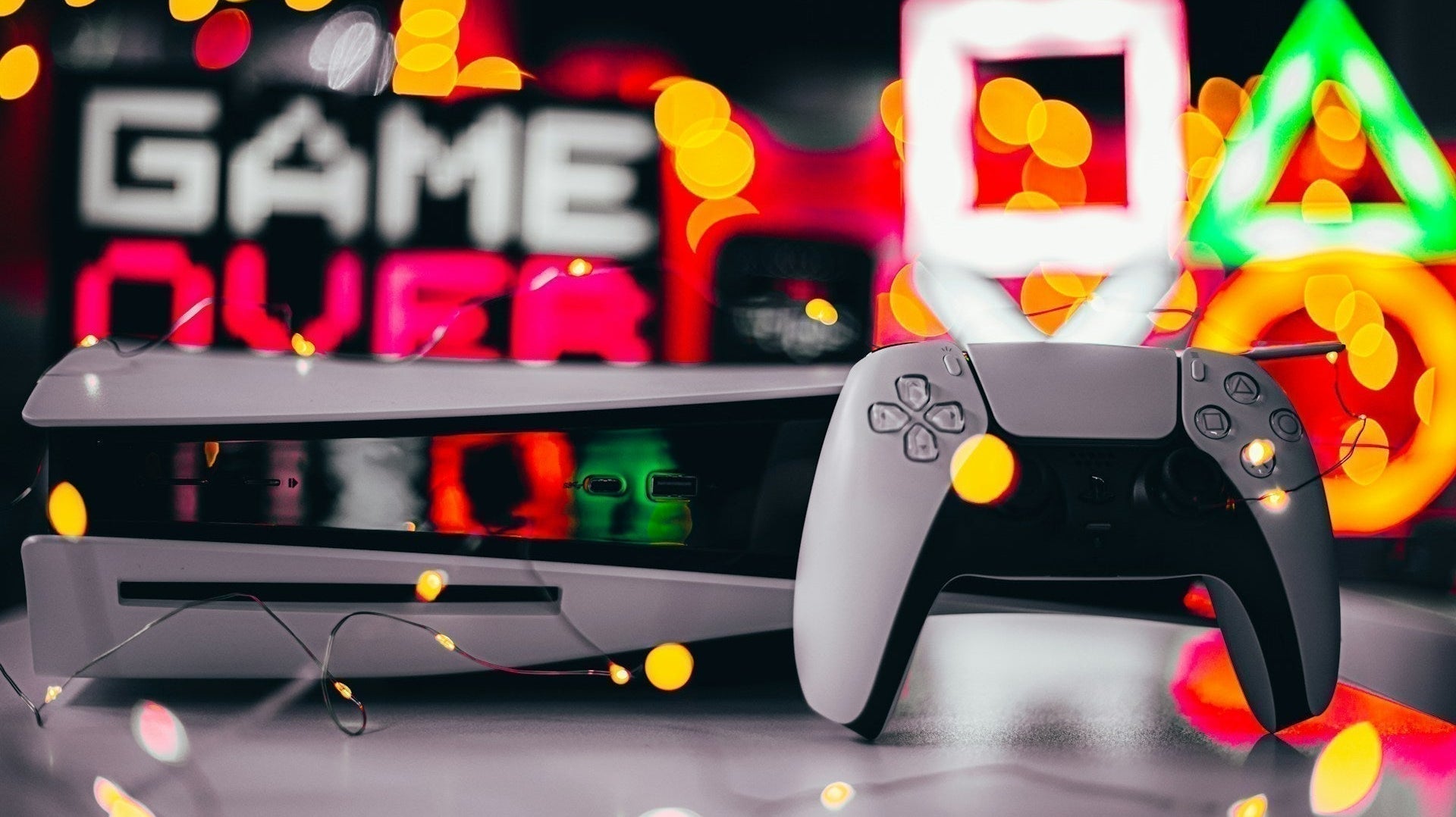 Perfect console gaming setup with neatly arranged controllers, LED lighting, and a clean entertainment station.