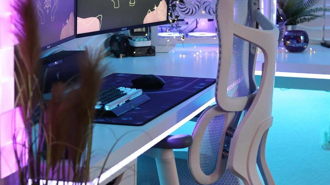 Modern gaming furniture setup featuring an ergonomic chair, RGB lighting, dual monitors, and a clean, stylish white desk layout.