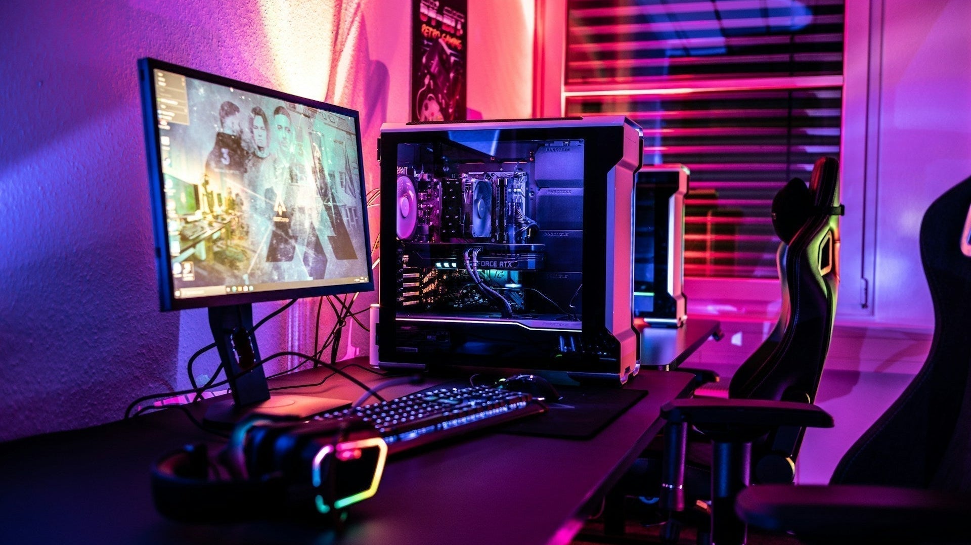 Gaming room LED setup with RGB PC, monitor, headset, and ergonomic gaming chairs in colourful lighting. Image by ELLA DON via ww.unsplash.com