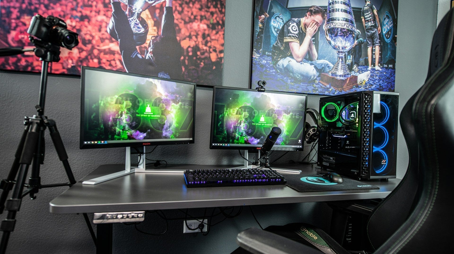 Professional gaming setup dual monitor with RGB PC, gaming chair, and streaming gear in a modern room.