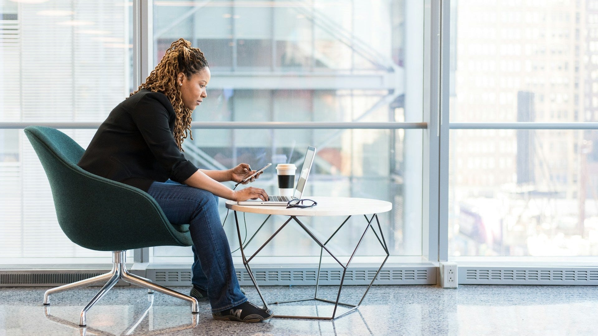 A woman working on a coffee table. Image by Christina @ wocintechchat.com via www.unsplash.com