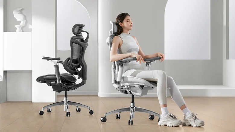 Woman relaxing in ergonomic chair, showcasing Office Chair Back Pain Solutions for better posture and comfort at work. Image by House Digest via https://www.housedigest.com