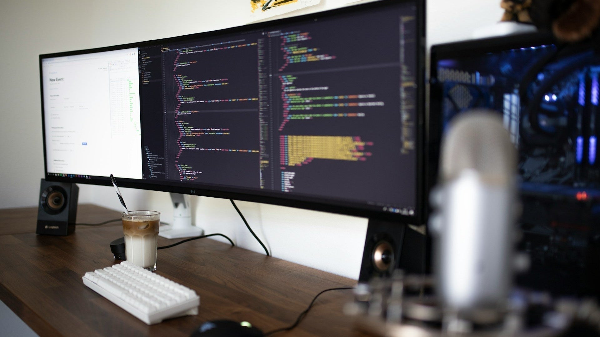 Modern workspace with wide monitors, coffee, and mic on wooden desk, showcasing sleek office design ideas home for productivity. Image by Caspar Camille Rubin via www.unsplash.com