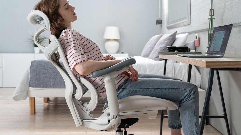 Woman lying back on the Doroc300, the ultimate ergonomic office chair for college students.