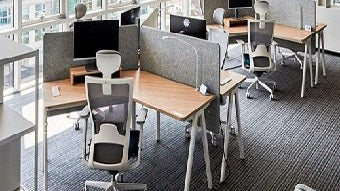 Ergonomic office chairs arranged with office tables inside a modern workspace, illustrating what is an office fit out and how proper furniture enhances comfort and productivity.