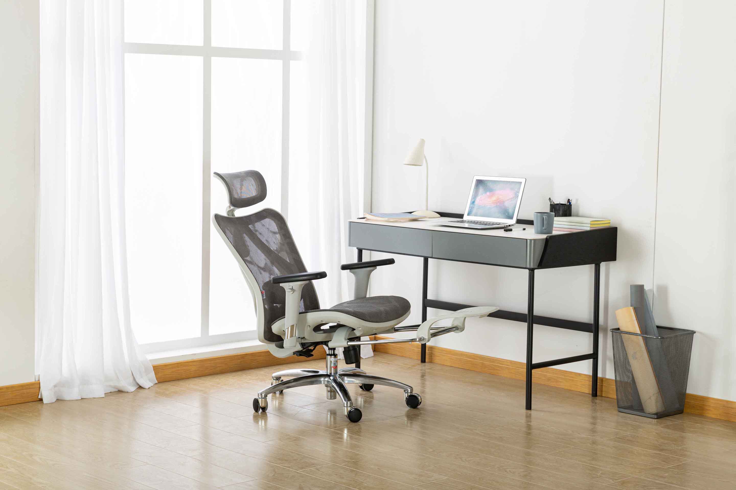 Front-right angled view of Sihoo M57 ergonomic chair in Australia with expandable built-in footrest in a modern home office setup