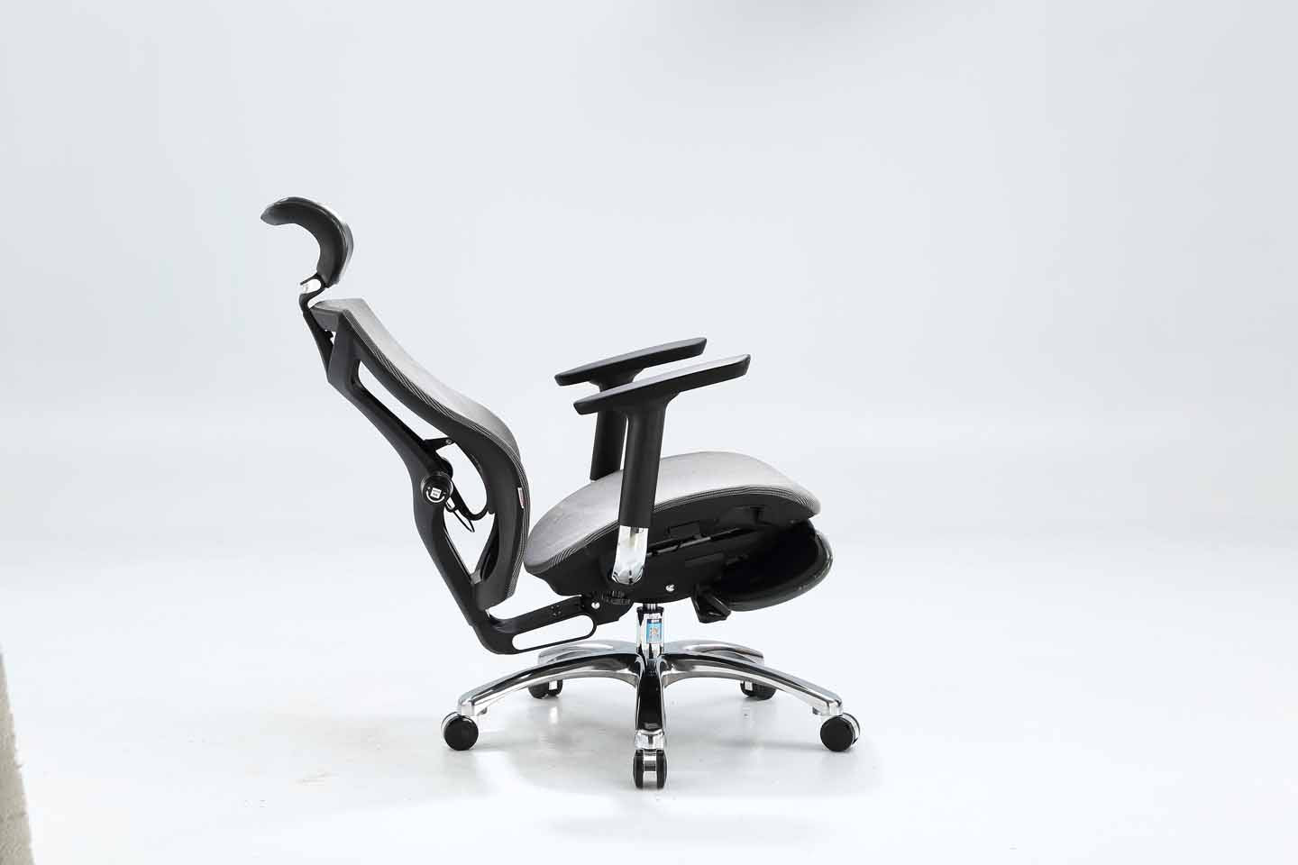 Right angle of black Sihoo V1 ergonomic chair in Australia with footrest in reclined setup on gray background, showcasing adjustable features and lumbar support