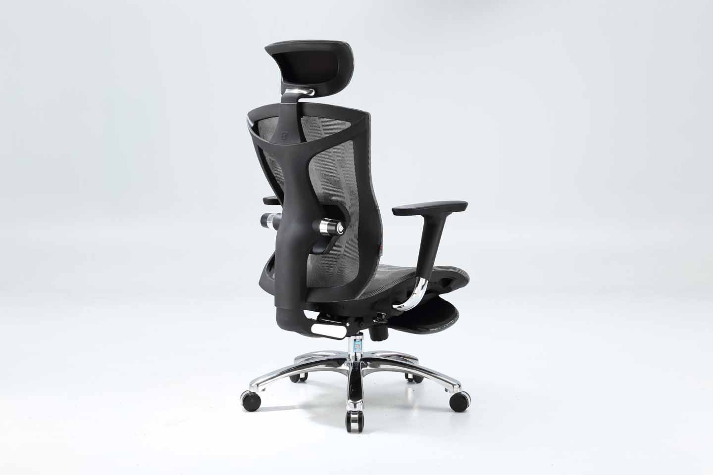 Semi back right angle of black Sihoo V1 ergonomic chair in Australia with footrest on gray background, emphasizing posture support and ergonomic design