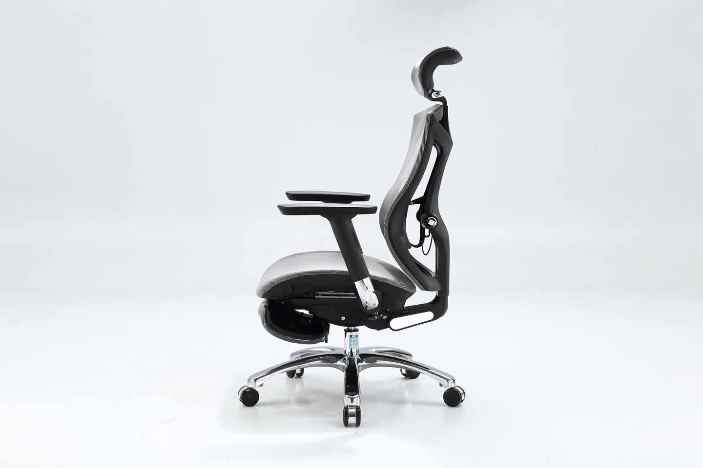 Left angle of black Sihoo V1 ergonomic chair in Australia with footrest on gray background, emphasizing posture support and adjustable features
