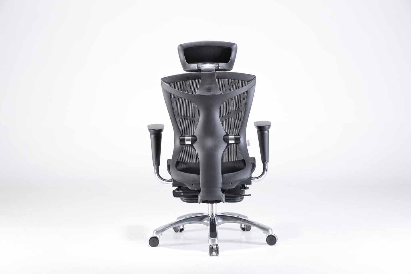 Back view of black Sihoo V1 ergonomic chair in Australia with footrest on a gray background, highlighting adjustable lumbar support and breathable mesh