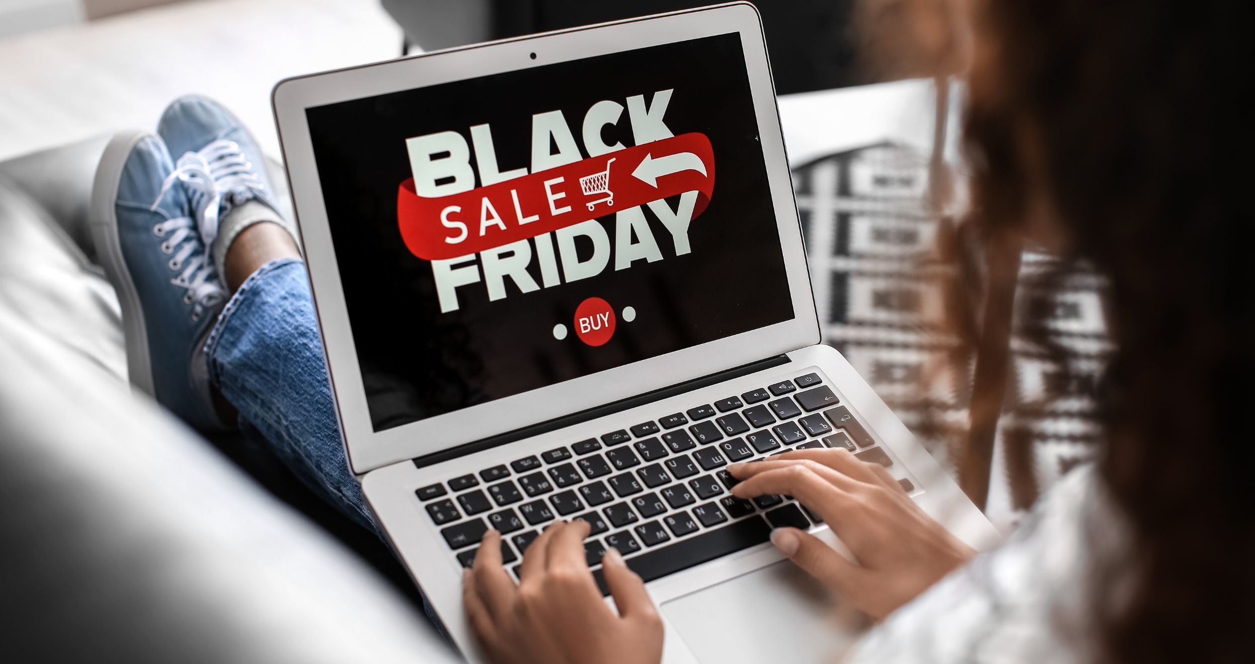 Laptop showing a Black Friday sale banner while checking deals for a black friday shopping guide.