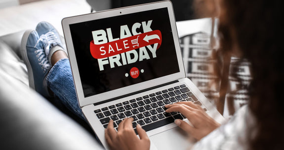 Laptop showing a Black Friday sale banner while checking deals for a black friday shopping guide.