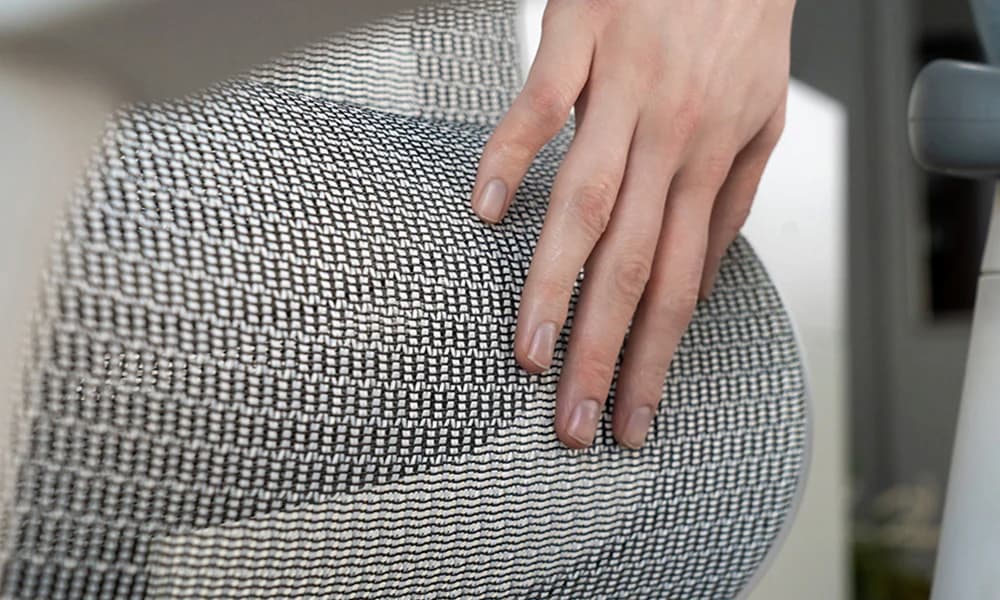 Close-up of a spotless ergonomic mesh chair illustrating how to clean an ergonomic office chair