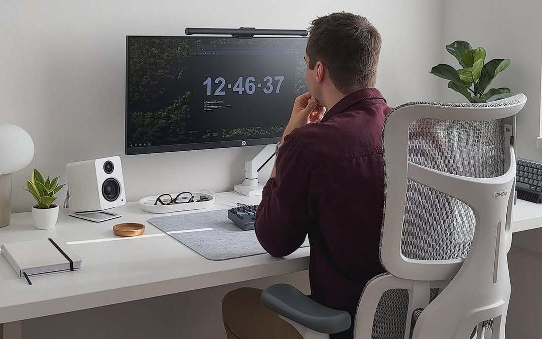 Minimalist workspace with laptop, notepad, and coffee-perfect for creating an EOFY 2025 guide setup.