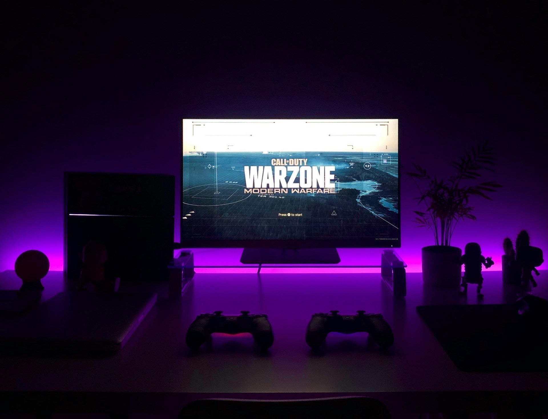 A dimly lit desk setup, with no cheap gaming chairs in sight. Photo by Fábio Magalhães on Unsplash
