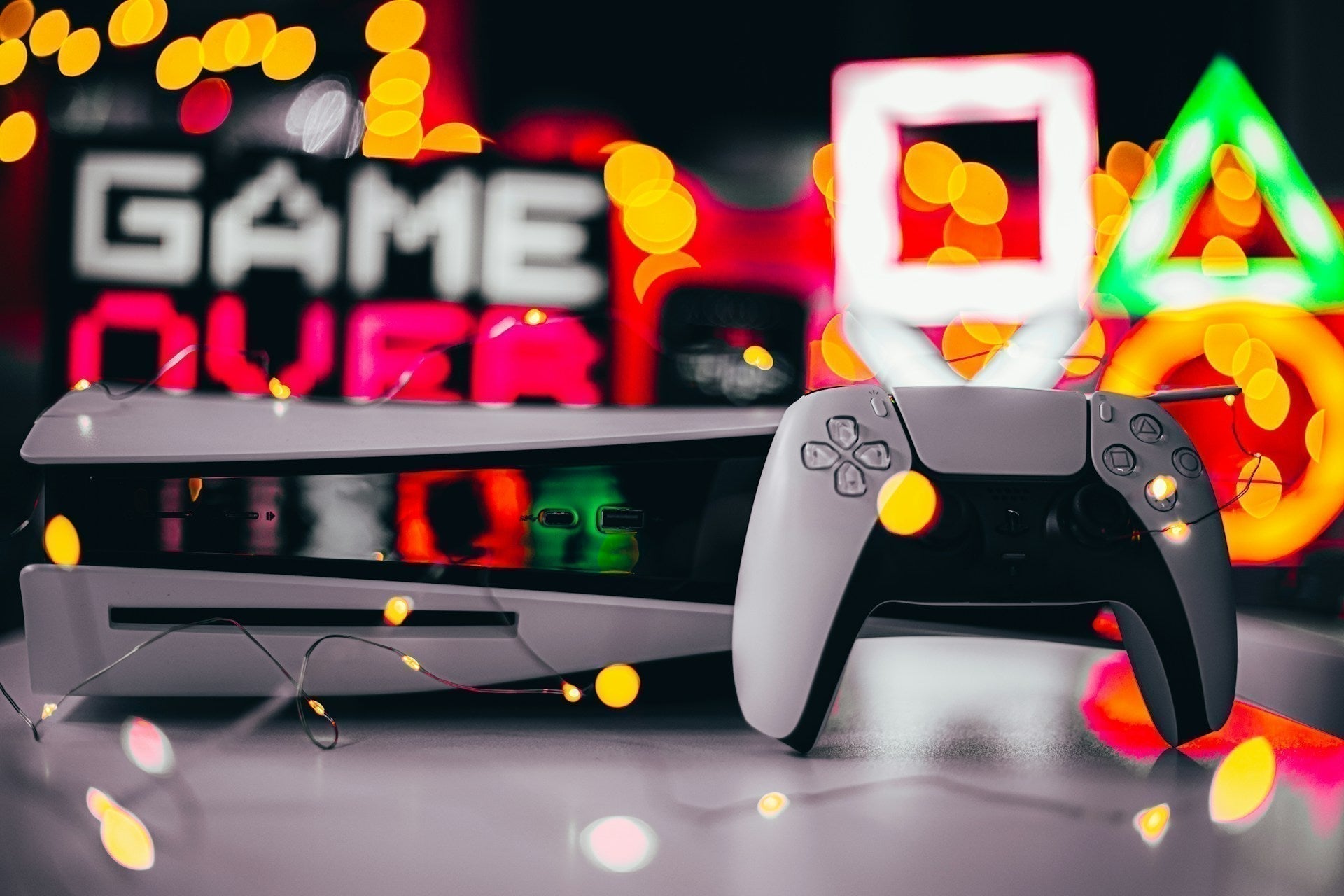 Perfect console gaming setup with neatly arranged controllers, LED lighting, and a clean entertainment station.