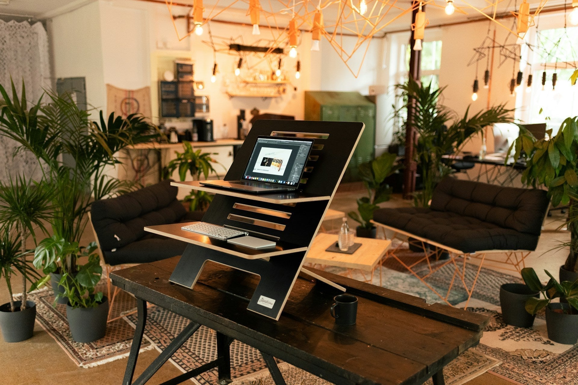 Modern hybrid home office setup featuring ergonomic standing desk, laptop, and natural décor, showcasing the best home office furniture for hybrid workers.