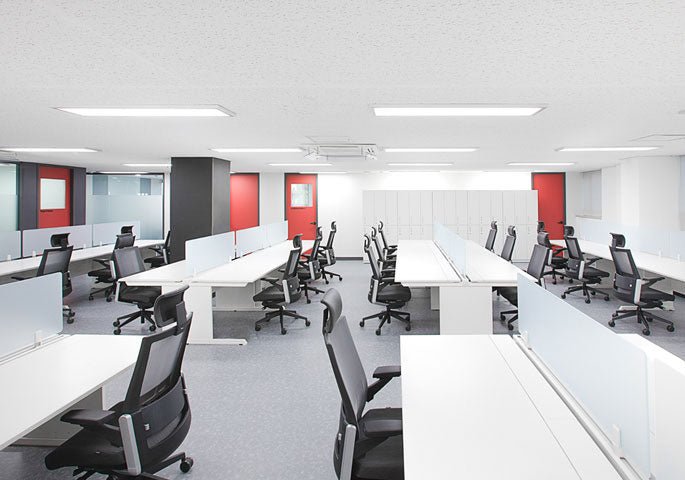 Modern commercial fit-out featuring open-plan workspace with ergonomic furniture and warm lighting.