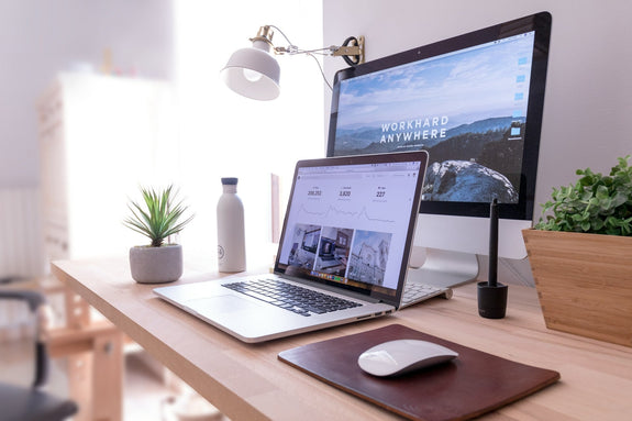 How to measure work productivity? A work station at home with sleek lighting and wooden fixture. Image by Domenico Loia via www.unsplash.com