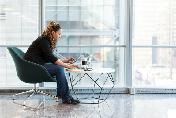 A woman working on a coffee table. Image by Christina @ wocintechchat.com via www.unsplash.com