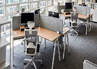 Ergonomic office chairs arranged with office tables inside a modern workspace, illustrating what is an office fit out and how proper furniture enhances comfort and productivity.