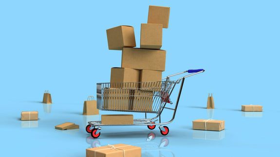 a shopping cart full of boxes. a scenery that likely happens during black friday, makes you want to question why black friday is celebrated. Image by Shutter Speed via www.unsplash.com