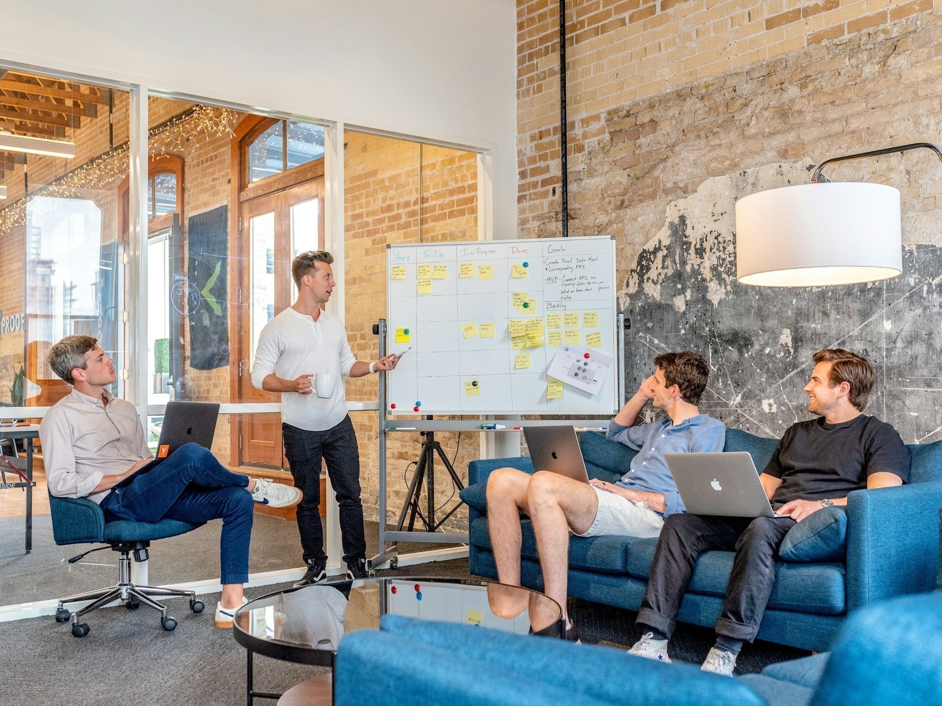 Team working with KPIs during a strategy meeting, discussing goals and performance metrics on a whiteboard.